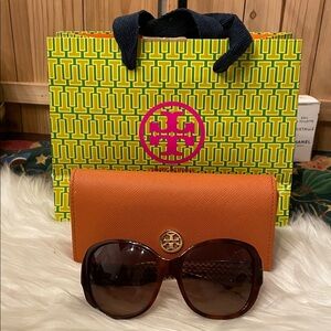 Tory Burch Brown Oversized Sunglasses featuring a tortoise frame & orange case